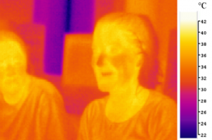 An image of two people in mid-infrared ("...